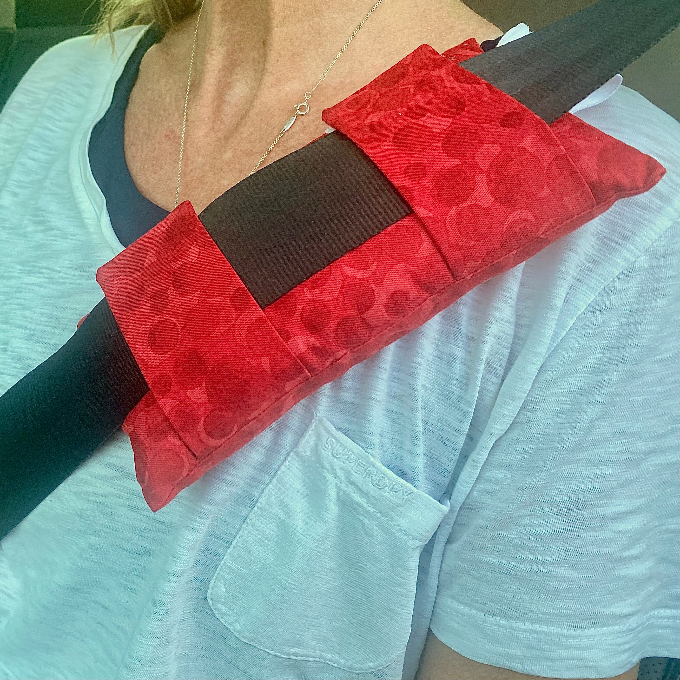 red seat belt pillow at upper part of body