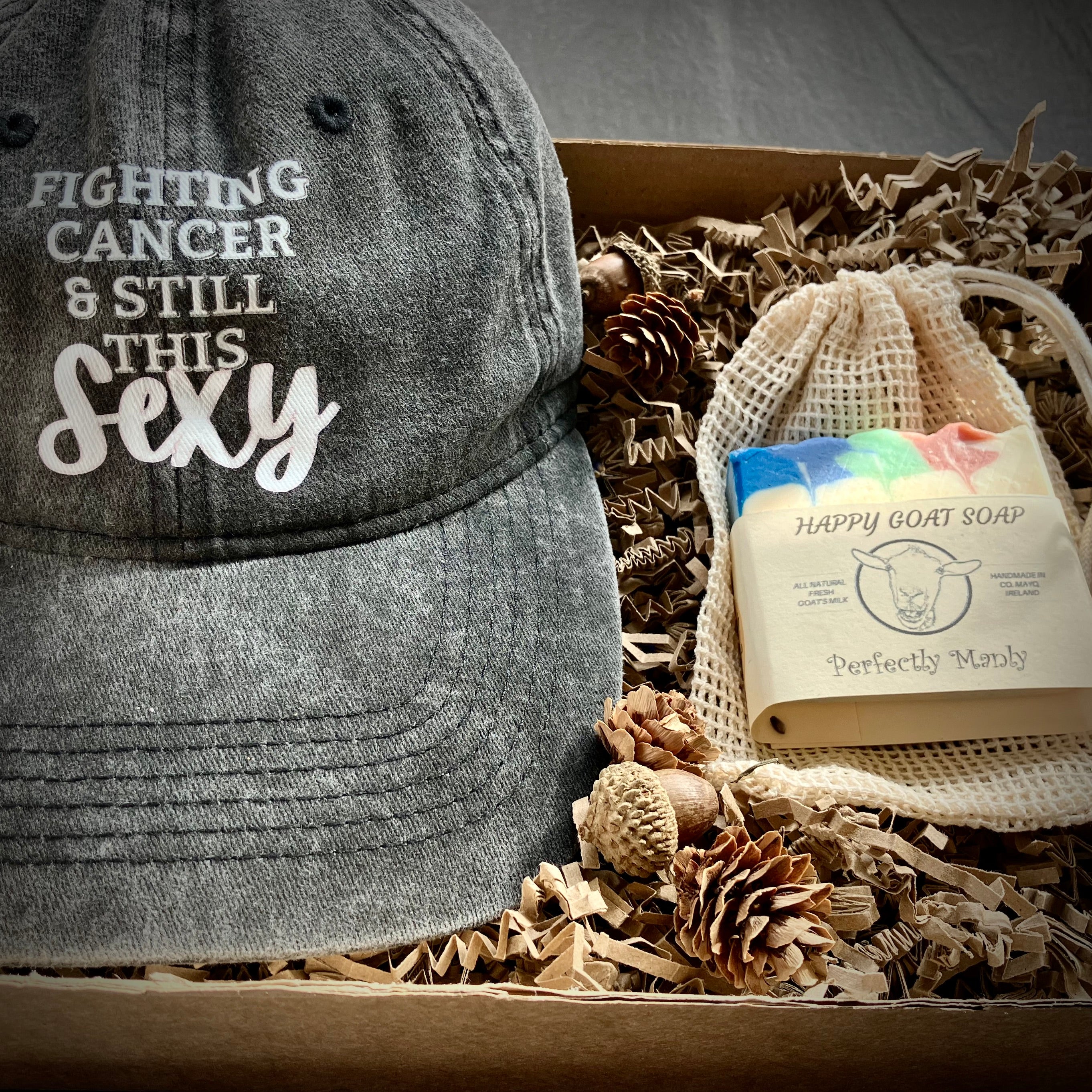 Care package with humorous cancer gifts. Baseball hat and Perfectly Manly goats milk soap.