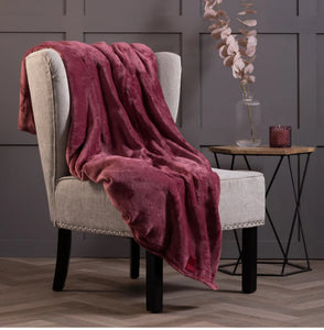 Thermal blanket in cherry pink over chair