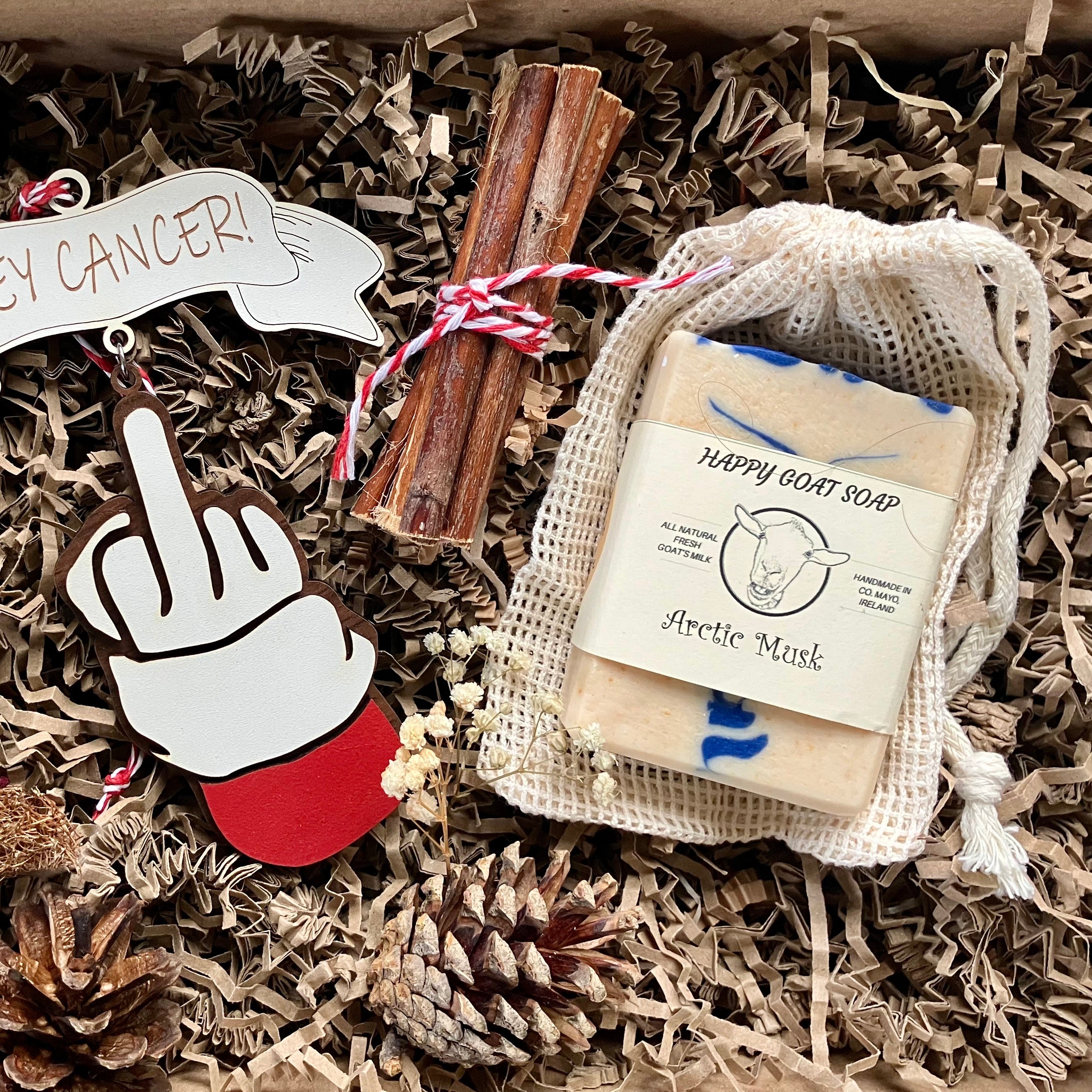 Christmas gift box for someone with cancer containing one finger salute decoration and goats milk soap for sensitive skin.